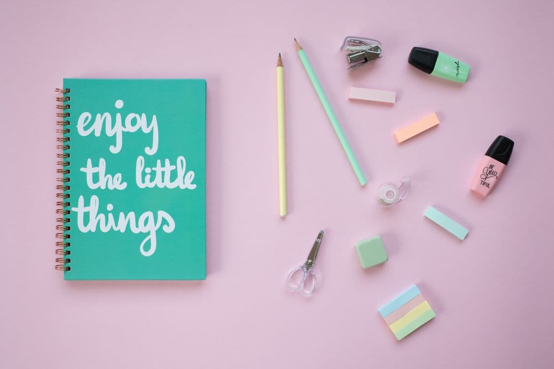 Pastel stationery and a notebook on a pink background